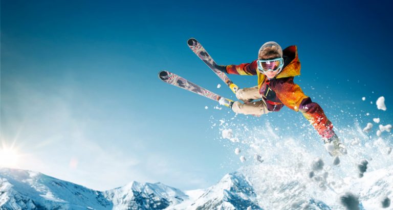 Skier jumping and doing a stunt in the snow