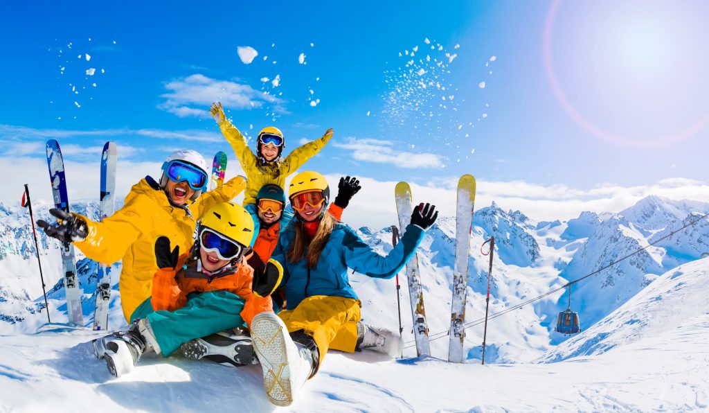 Group of friend poising with their skis