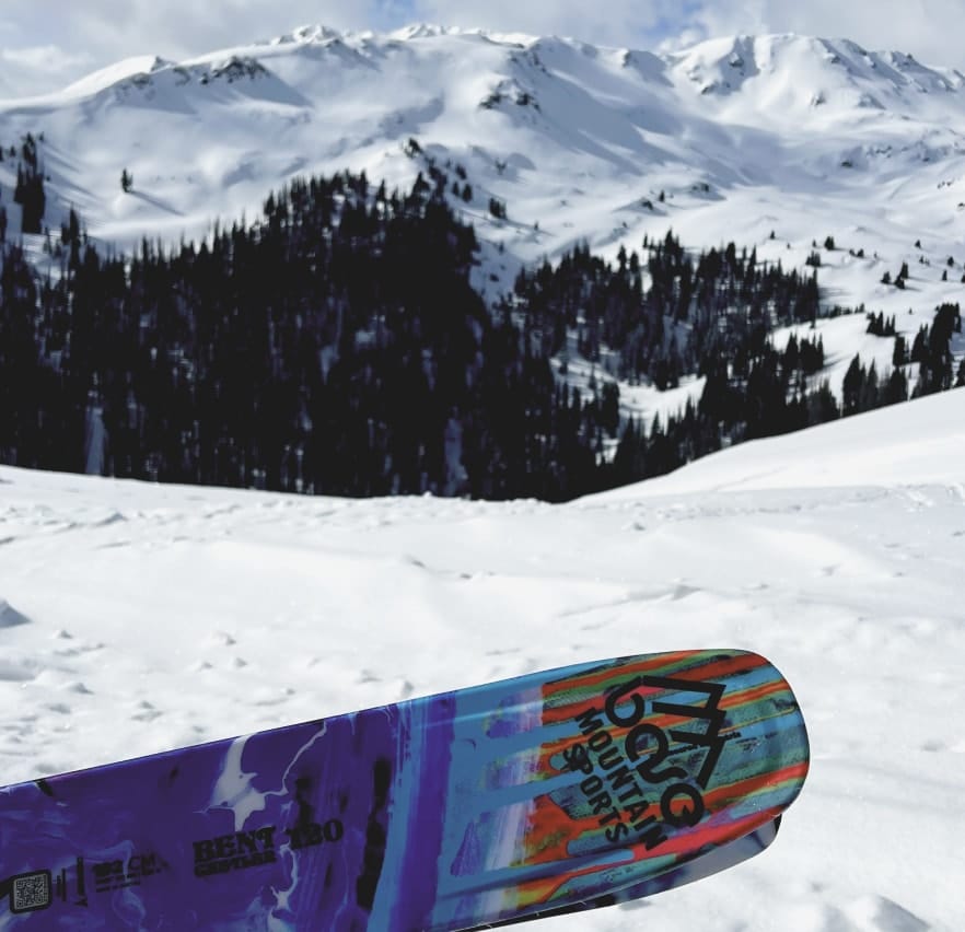 Base Mountain Sports branded ski with snowy Colorado mountain in background